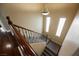 Bright stairway with carpeted steps, hardwood floors and decorative wrought iron railings at 9173 Whitekirk Pl, Las Vegas, NV 89145