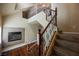 Staircase with wood and wrought iron railings, and a gas fireplace at 9173 Whitekirk Pl, Las Vegas, NV 89145