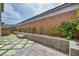 Backyard area with artificial turf, pavers, and brick retaining wall at 9370 Burning Sage Ave, Las Vegas, NV 89149