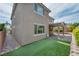 Backyard featuring lush grass, covered patio, and brick landscaping at 9370 Burning Sage Ave, Las Vegas, NV 89149