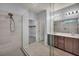 A modern bathroom featuring a glass-enclosed shower, dual sinks, and a walk-in closet at 9370 Burning Sage Ave, Las Vegas, NV 89149