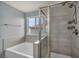 Modern bathroom featuring a soaking tub, shower with dual heads, and a window at 9370 Burning Sage Ave, Las Vegas, NV 89149
