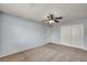 Bedroom with neutral carpet, light gray walls, ceiling fan and two doors at 9370 Burning Sage Ave, Las Vegas, NV 89149