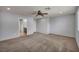 Spacious bedroom featuring neutral carpet and a ceiling fan with an ensuite bathroom at 9370 Burning Sage Ave, Las Vegas, NV 89149