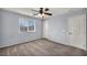 A standard bedroom featuring a ceiling fan, window and two doors at 9370 Burning Sage Ave, Las Vegas, NV 89149