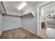 Walk-in closet featuring neutral colored carpet, shelving, and closet rod hardware at 9370 Burning Sage Ave, Las Vegas, NV 89149