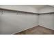 Walk-in closet with neutral colored carpet, shelving and closet rod hardware at 9370 Burning Sage Ave, Las Vegas, NV 89149