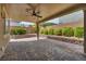 Comfortable covered patio with stylish brick pavers, ceiling fan, and well-maintained landscaping for privacy at 9370 Burning Sage Ave, Las Vegas, NV 89149