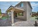 Stunning view of a well-maintained backyard with brick pavers, lush landscaping, and an inviting covered patio at 9370 Burning Sage Ave, Las Vegas, NV 89149