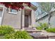Close up of home's entrance with tiled staircase and mature landscaping at 9370 Burning Sage Ave, Las Vegas, NV 89149