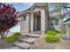 Inviting front entrance with brick steps, neutral stucco, and colorful landscaping create excellent curb appeal at 9370 Burning Sage Ave, Las Vegas, NV 89149