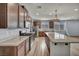 Modern kitchen with a large island, stainless steel appliances, and wood-look floors at 9370 Burning Sage Ave, Las Vegas, NV 89149
