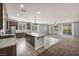 Open kitchen and living area featuring an island with seating, stainless appliances, and wood floors at 9370 Burning Sage Ave, Las Vegas, NV 89149