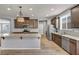 Open-concept kitchen boasts a kitchen island, recessed lights, and stainless steel appliances at 9370 Burning Sage Ave, Las Vegas, NV 89149