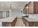 Spacious kitchen featuring an island, wood floors, stainless steel appliances, and light countertops at 9370 Burning Sage Ave, Las Vegas, NV 89149