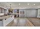 Open-concept living area with kitchen, plank flooring and recessed lighting throughout at 9370 Burning Sage Ave, Las Vegas, NV 89149