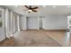 Spacious living room featuring light gray walls, a ceiling fan, and recessed built-in wall features at 9370 Burning Sage Ave, Las Vegas, NV 89149