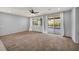 Bright living room featuring recessed lighting, neutral walls, and access to the backyard at 9370 Burning Sage Ave, Las Vegas, NV 89149