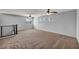 Large loft featuring light gray walls, carpeted floors, and multiple windows for natural light at 9370 Burning Sage Ave, Las Vegas, NV 89149