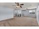 Open loft featuring light gray walls, two ceiling fans and carpeted floors at 9370 Burning Sage Ave, Las Vegas, NV 89149