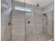 A modern shower featuring gray tiling and a seamless glass enclosure at 9370 Burning Sage Ave, Las Vegas, NV 89149