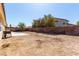 View of backyard with a concrete patio, grill, and cinder block wall at 1185 Ponce De Leon Ave, Las Vegas, NV 89123