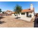 The backyard features a concrete patio, a tree and a stucco wall at 1185 Ponce De Leon Ave, Las Vegas, NV 89123