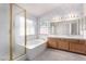 Bathroom area features a soaking tub, double sinks, and tile flooring at 1185 Ponce De Leon Ave, Las Vegas, NV 89123