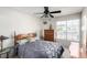 This bedroom features a ceiling fan, a bed, a dresser, and a window at 1185 Ponce De Leon Ave, Las Vegas, NV 89123