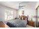Cozy bedroom featuring a ceiling fan, carpet, natural light, and wooden furniture at 1185 Ponce De Leon Ave, Las Vegas, NV 89123