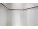 Walk-in closet features wooden clothes bars and a shelf at 1185 Ponce De Leon Ave, Las Vegas, NV 89123