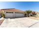Exterior view of a charming single-story home featuring a three car garage and desert landscaping at 1185 Ponce De Leon Ave, Las Vegas, NV 89123