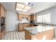 Kitchen area has tile floors and countertops, stainless steel appliances, and wooden cabinets at 1185 Ponce De Leon Ave, Las Vegas, NV 89123