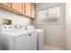 Bright laundry room with white washer and dryer and tile flooring at 1185 Ponce De Leon Ave, Las Vegas, NV 89123