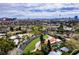 Expansive aerial view of a charming Las Vegas property with lush landscaping and a view of the city skyline at 1450 Rancho Cir, Las Vegas, NV 89107