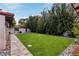 Well-manicured backyard with lush greenery, stone pathway, and mature trees providing a peaceful outdoor oasis at 1450 Rancho Cir, Las Vegas, NV 89107