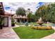 Serene backyard featuring a fountain, a fire pit, and meticulously maintained landscaping at 1450 Rancho Cir, Las Vegas, NV 89107