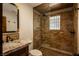 Beautiful bathroom featuring a granite countertop and stand up shower with a glass block window at 1450 Rancho Cir, Las Vegas, NV 89107