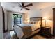 Comfortable bedroom with a ceiling fan, large window and view to the outside at 1450 Rancho Cir, Las Vegas, NV 89107