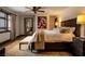 This bedroom features a ceiling fan, modern art, and a lovely throw blanket at 1450 Rancho Cir, Las Vegas, NV 89107