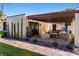 Inviting covered patio with comfortable seating, stone pathway, and lush greenery for relaxed outdoor living at 1450 Rancho Cir, Las Vegas, NV 89107