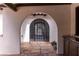 Arched entryway with custom iron gate and stone flooring, creating a grand entrance at 1450 Rancho Cir, Las Vegas, NV 89107
