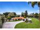 Expansive grounds, porte cochere, and lush landscaping define the exterior of this distinctive, sprawling estate home at 1450 Rancho Cir, Las Vegas, NV 89107