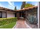 Charming home exterior featuring a lush walkway, terra cotta roof, and decorative plants at 1450 Rancho Cir, Las Vegas, NV 89107