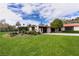 Lush front lawn and landscaping, with a front circular drive, provide a luxurious approach to the estate home at 1450 Rancho Cir, Las Vegas, NV 89107