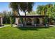 Charming guest house with a covered patio, arched windows, and lush greenery in a private backyard setting at 1450 Rancho Cir, Las Vegas, NV 89107
