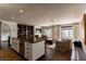 Bright kitchen with a stainless steel refrigerator, dark wood island, and view to the living area at 1450 Rancho Cir, Las Vegas, NV 89107