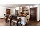 Bright kitchen with a stainless steel refrigerator, hood and dark wood island with seating for four at 1450 Rancho Cir, Las Vegas, NV 89107