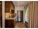 A quaint kitchenette featuring stainless steel appliances, dark wood cabinetry, and tiled countertops and backsplash at 1450 Rancho Cir, Las Vegas, NV 89107