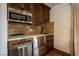 This kitchenette features stainless steel appliances and custom wood cabinetry at 1450 Rancho Cir, Las Vegas, NV 89107